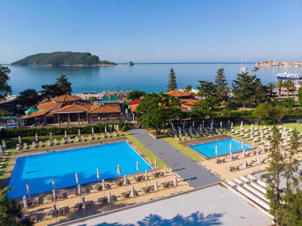 Hotel pools with the Adriatic sea and Budva Old Town behind